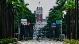 A police officer runs across an empty street of the downtown area during an air raid drill as part of the annual Han Kuang military exercises, in Taipei, Taiwan, 17 July 2025.