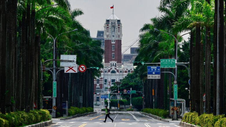 A police officer runs across an empty street of the downtown area during an air raid drill as part of the annual Han Kuang military exercises, in Taipei, Taiwan, 17 July 2025.