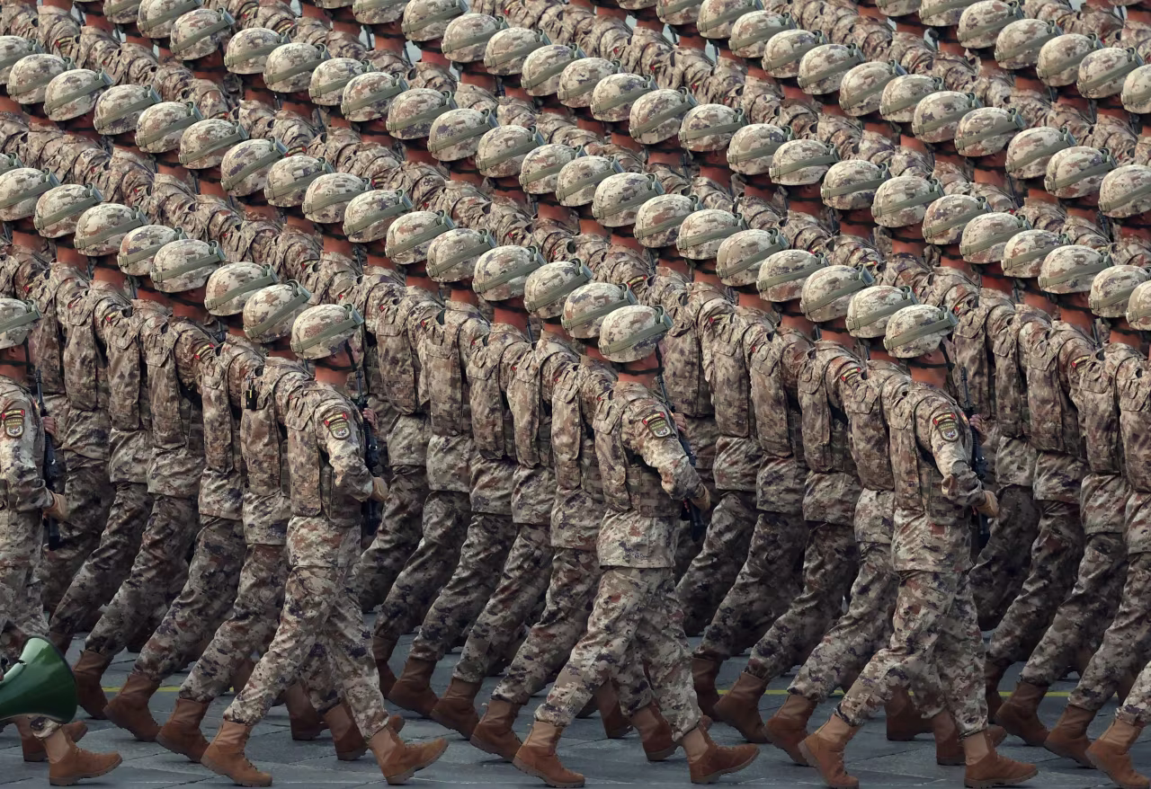 Chinese servicemen march in formation.
