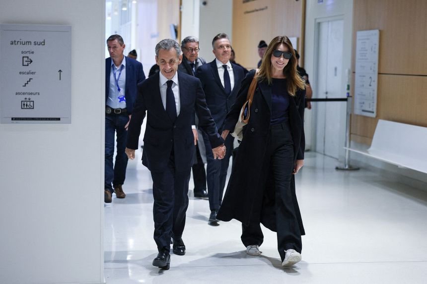 The former French leader supported his wife, singer and model Carla Bruni Sarkozy, in court.