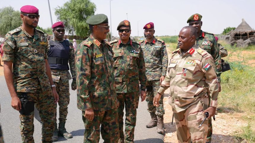 This photo, taken with a mobile phone on September 27, 2025, shows SAF leader Abdel Fattah Al-Burhan (3rd L) talking with military commanders in El Obeid, North Kordofan State, Sudan.