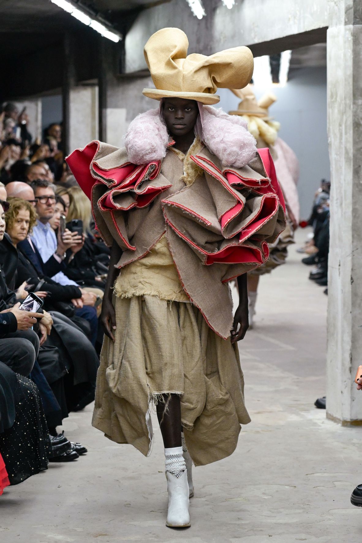 Designer Rei Kawakubo transformed coarse burlap into larger-than-life creations for the Comme des Garçons' Spring-Summer 2026 show.