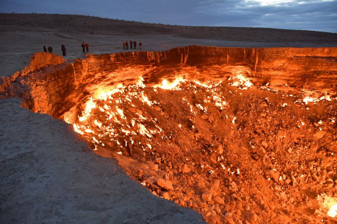 <strong>Welcome to the 'Gates Of Hell':</strong> Visitors line the edge of the Darvaza "Gates of Hell" gas crater in Turkmenistan's Karakum Desert.