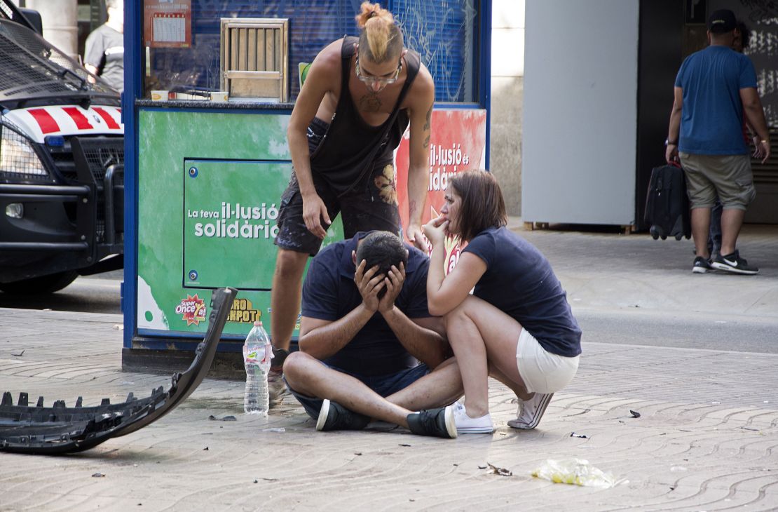 Injured people react after a van crashed into pedestrians in the Las Ramblas section of downtown Barcelona, Spain.