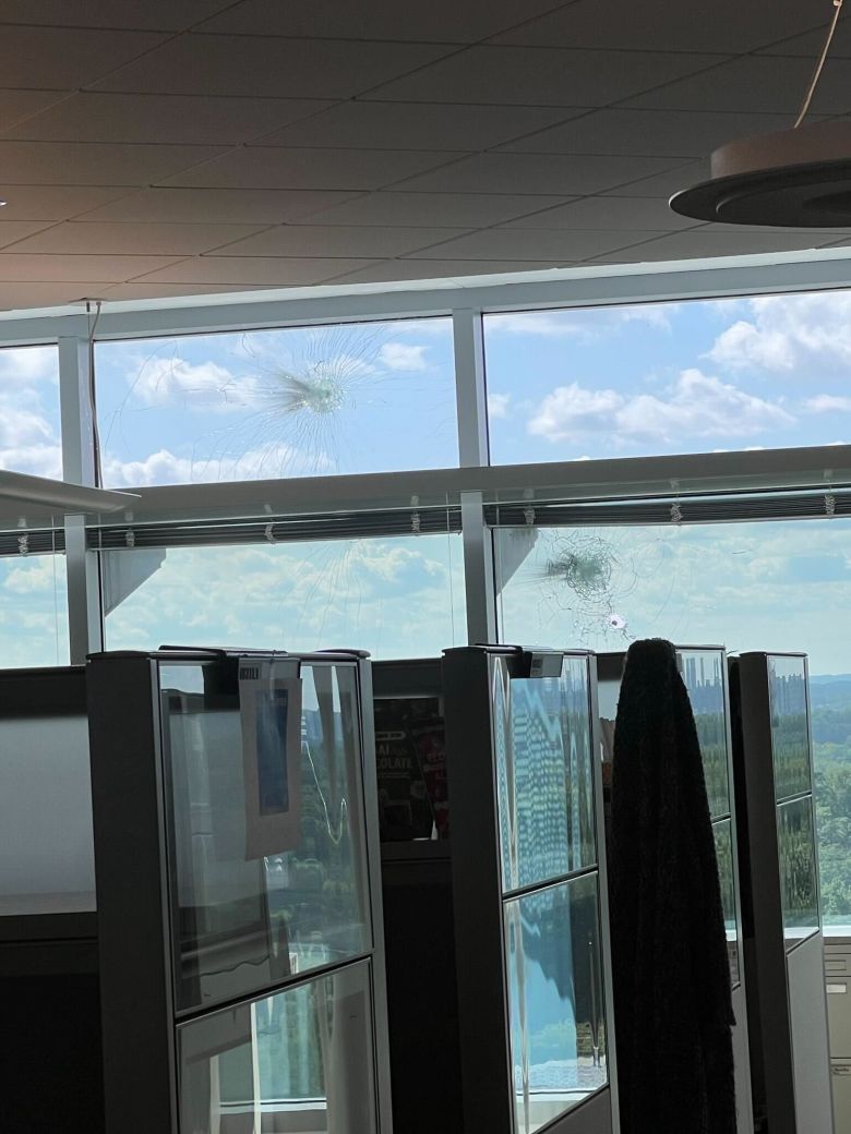 A CDC employee shared photos showing bullet holes in windows near cubicles at building 24 of CDC headquarters on Friday.