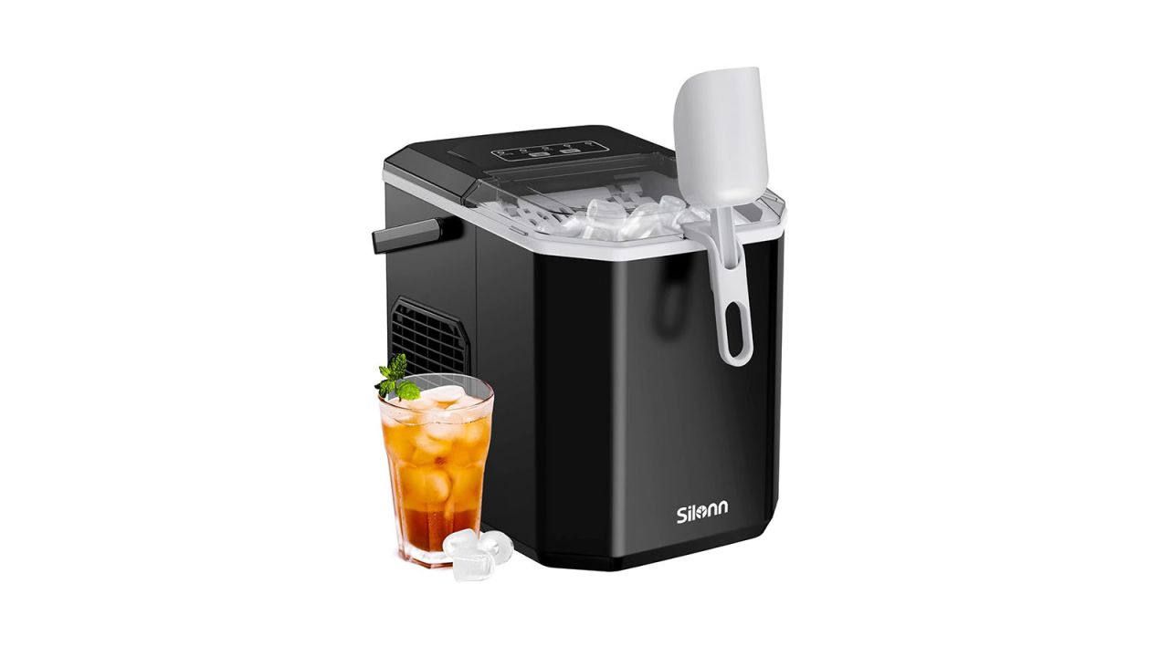 Ice maker with small drink placed in front and scooper hanging off the lid.