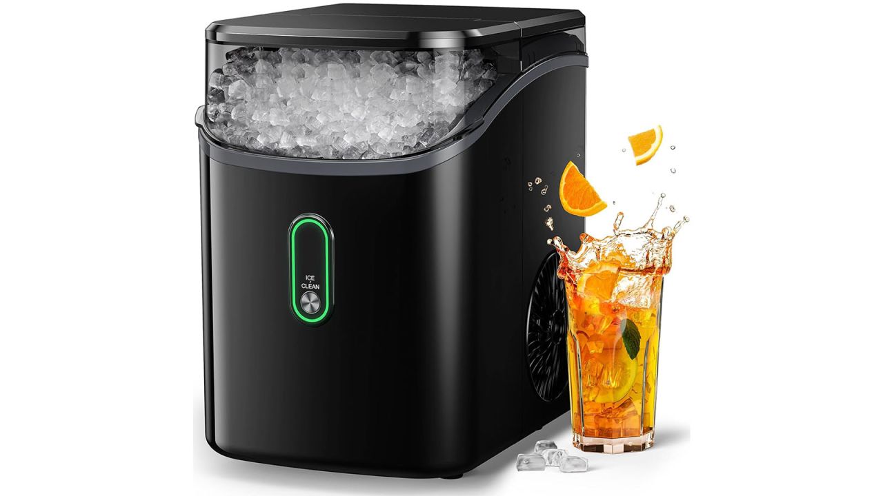 Ice maker with drink placed next to it.