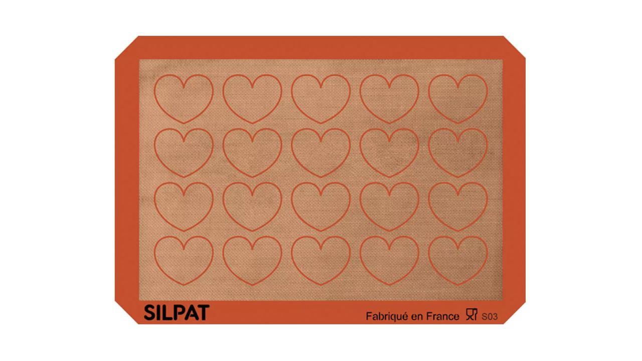 A reusable baking mat with 20 hearts on it.