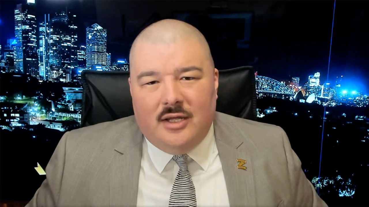 Simeon Boikov, seen here in a video taken in the Russian consulate in Sydney where he is currently seeking asylum, paid an American X user $100 to post content, some of which has since been deemed Russian disinformation.