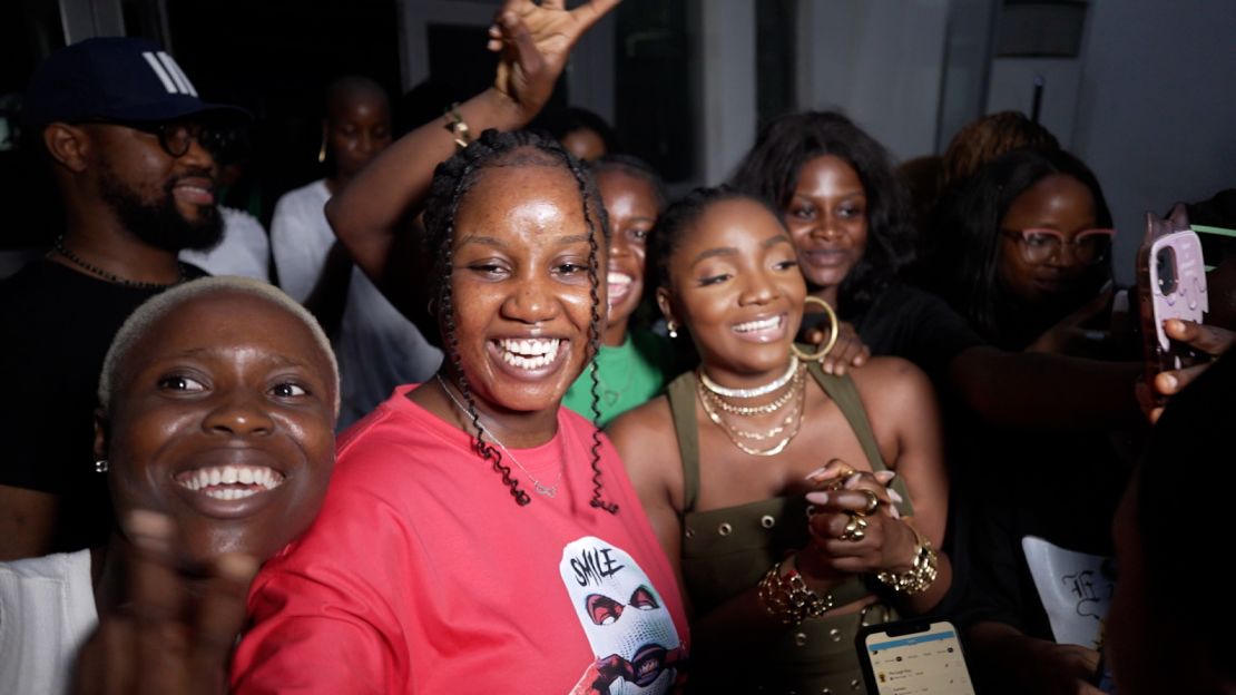 Simi (center-right, wearing olive green) greets her fans in Lagos, Nigeria.