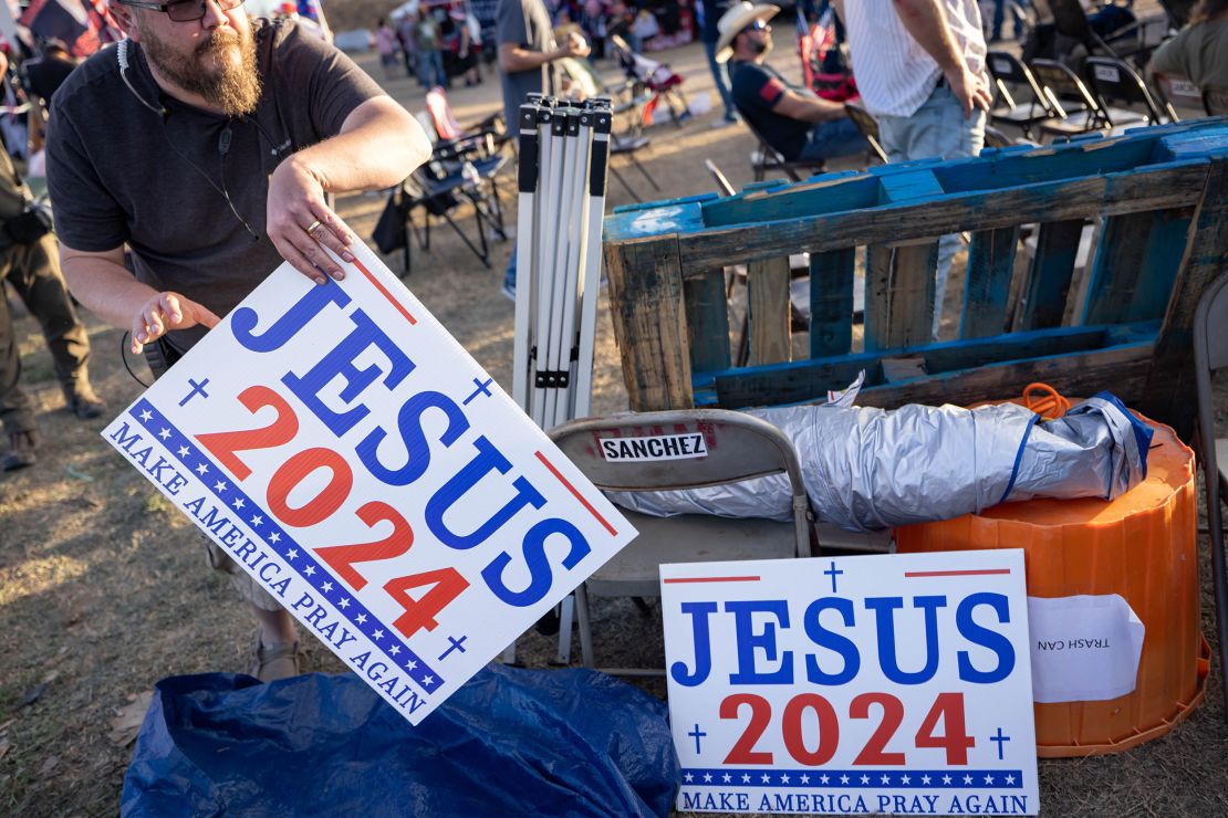 A man takes a "Jesus 2024" sign at the Cornerstone Children's Ranch during the "Take Our Border Back" convoy rally on February 3, 2024, in Quemado, Texas.
