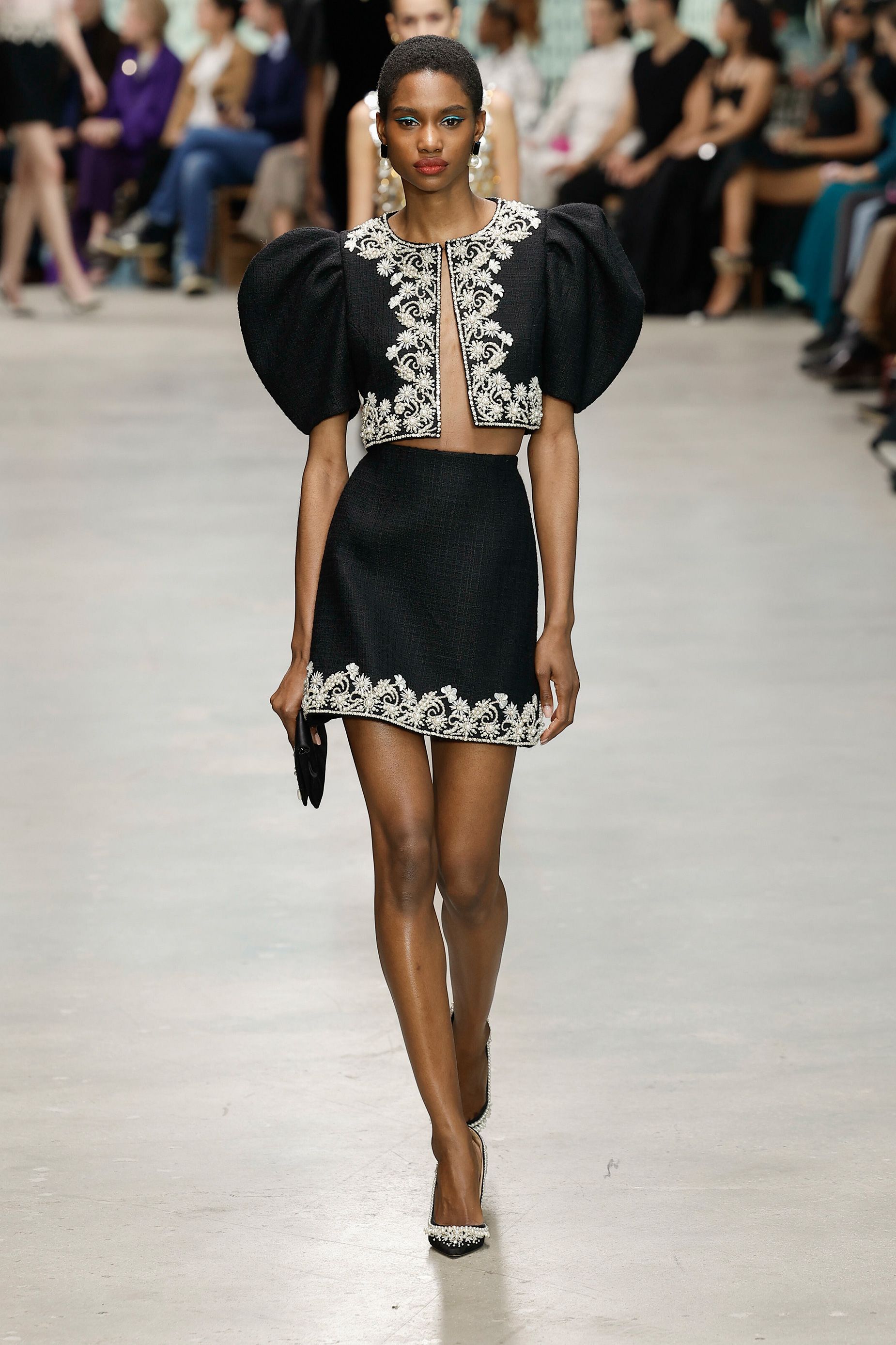 His latest collection contrasted architectural shapes with ruffles and swirling embroidery.