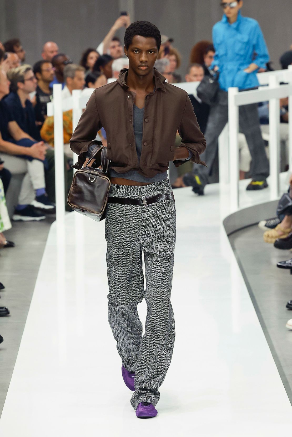 Dropped-waist belts were painted onto trousers in the style of tromp l’oeil at Prada.