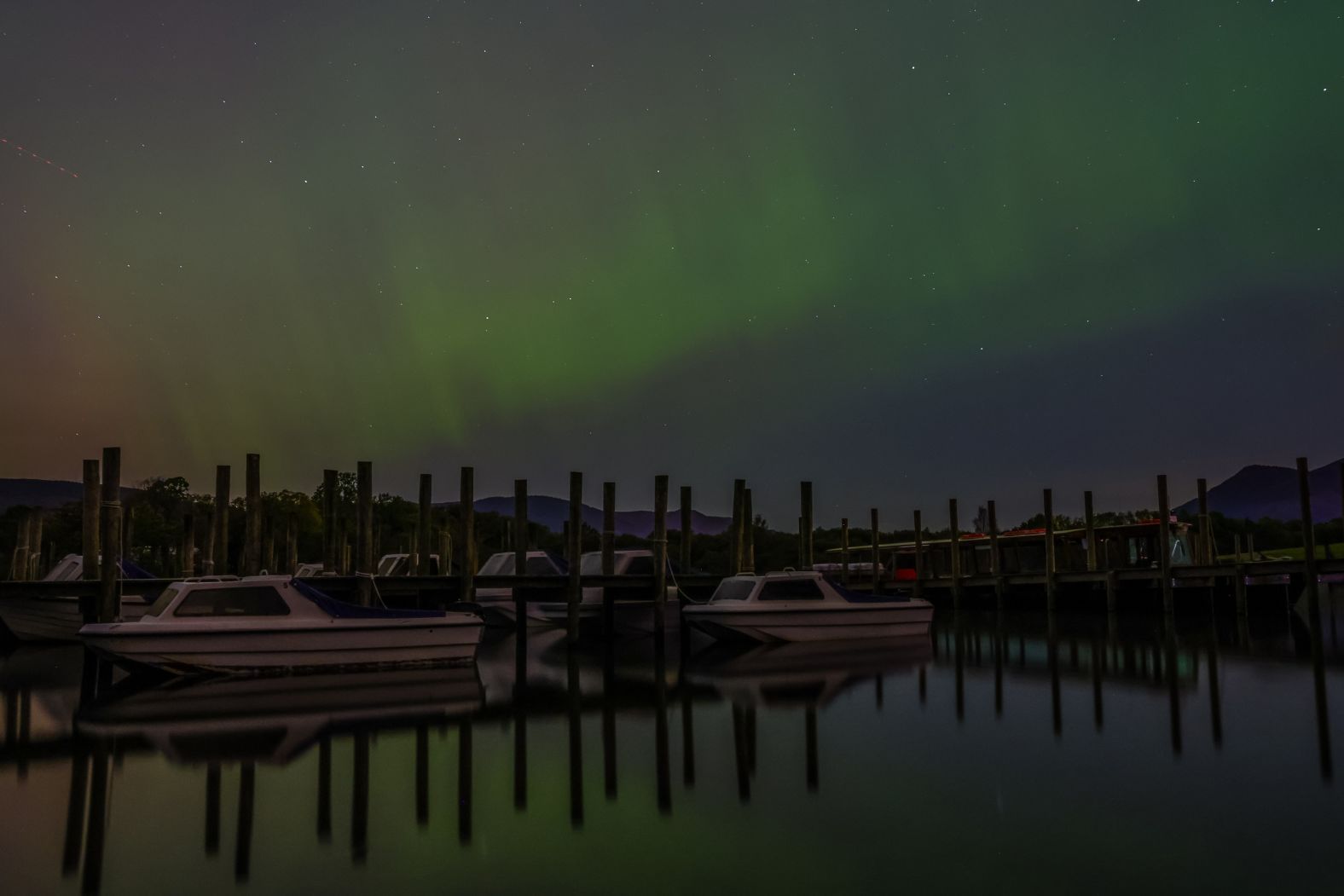 The northern lights shine Thursday over a lake near Keswick, England.