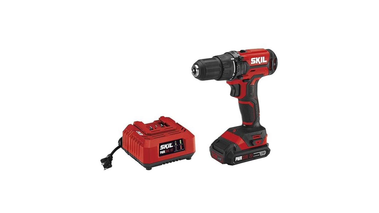 Small drill placed next to charging station.