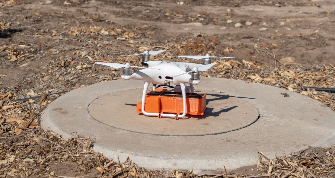 A drone prepares for a test flight, with the cartridge visible beneath it.