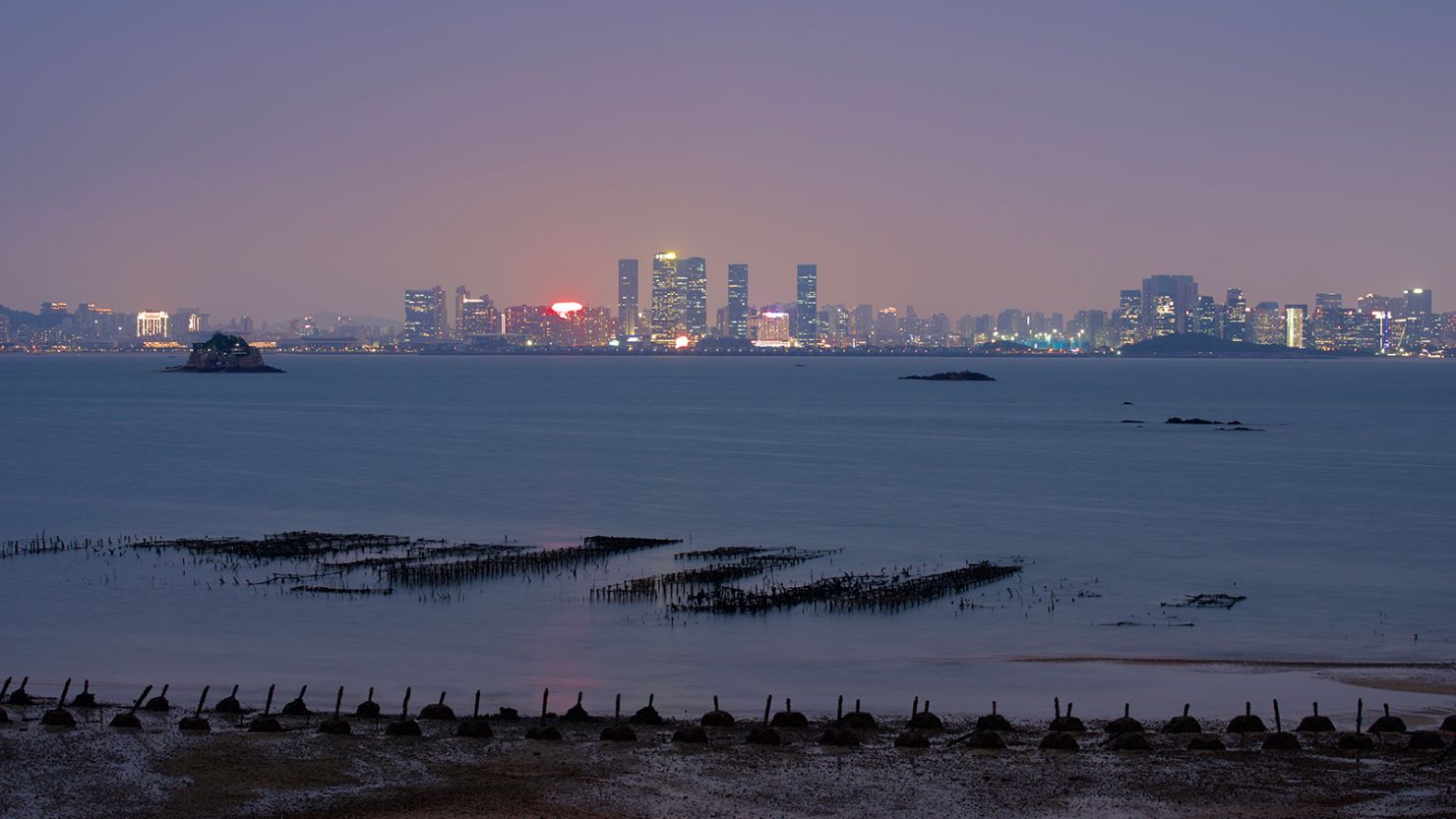 The gleam of city lights on China's coast seen from Taiwan's Kinmen islands.
