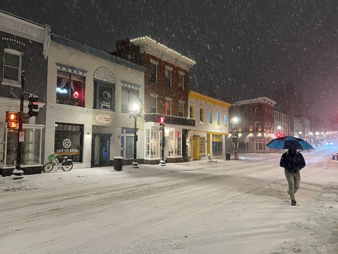 Snowfall covers the streets of the Georgetown neighborhood in Washington, DC on Monday morning