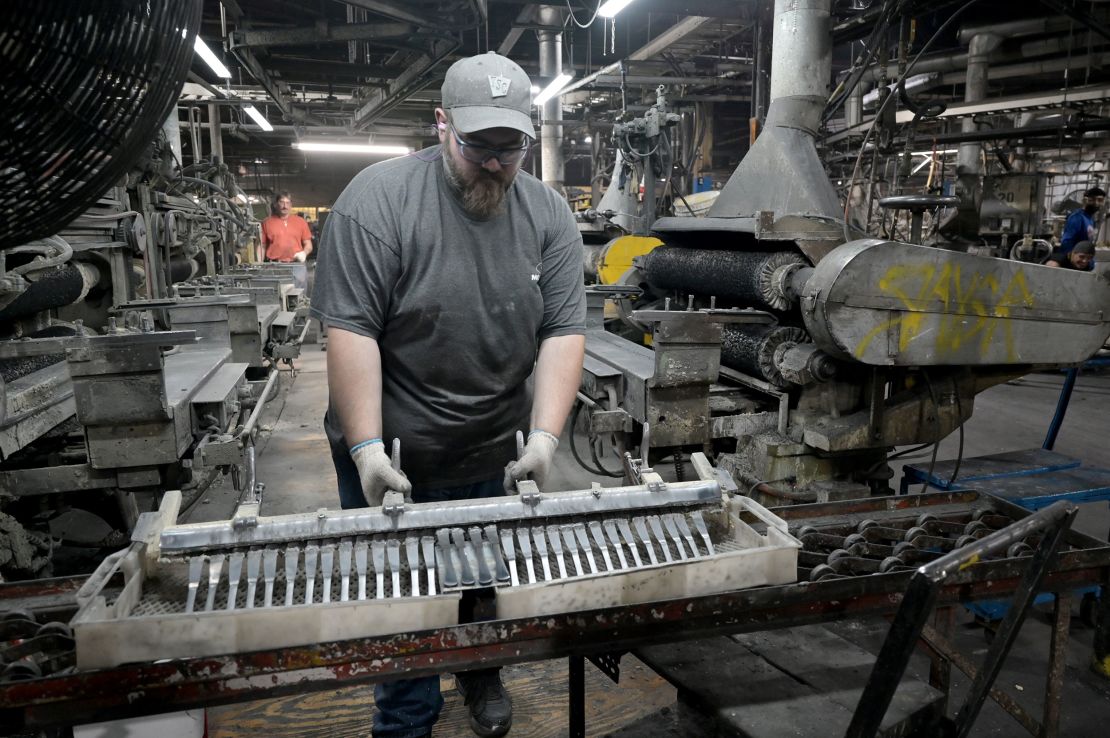Solid dinner knives coming out of the buff unit at the Liberty Tabletop factory.