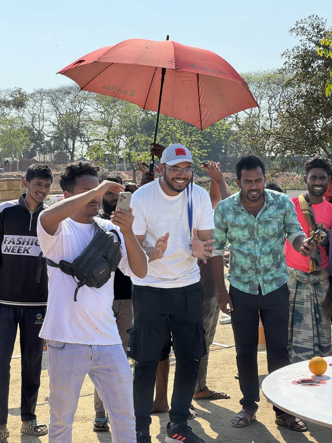 Somrat (center) is the creator of the games. He is pictured with his team on March 6, 2024 in Banwarinagar village in the Pabna District.