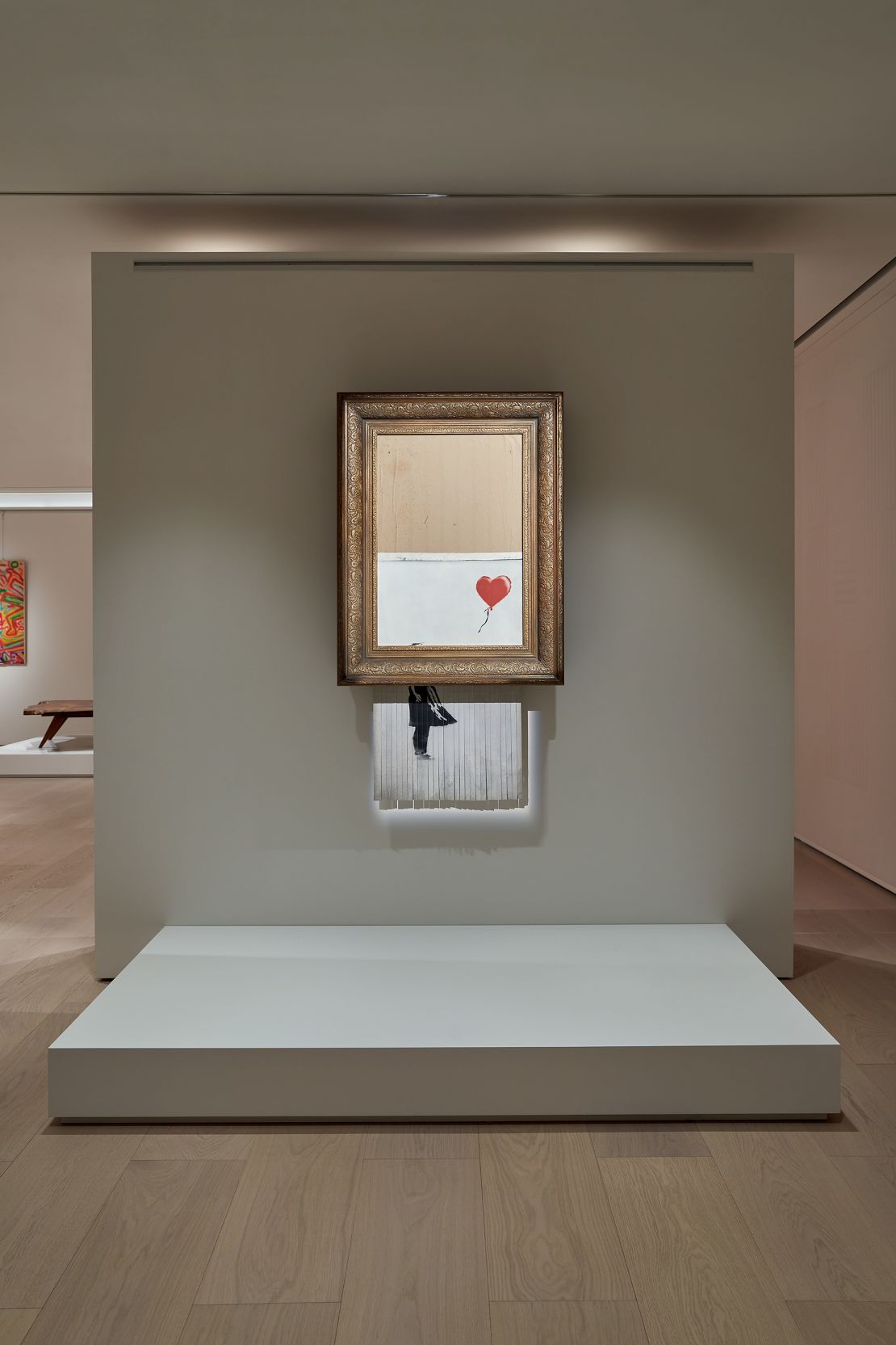 Banksy's "Love is in the Bin" is on display. The painting famously slid into a shredder hidden inside its frame just seconds after selling at auction in 2018.