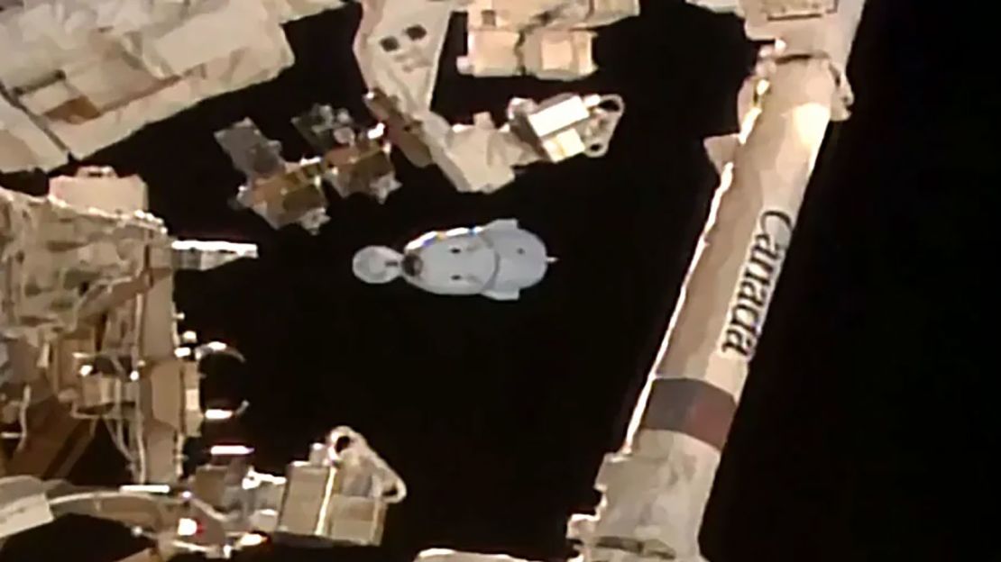 The SpaceX Dragon Endeavor spacecraft is photographed behind the Candarm2 robotic arm moments after separating from the space station's Harmony module with four Crew-8 members.