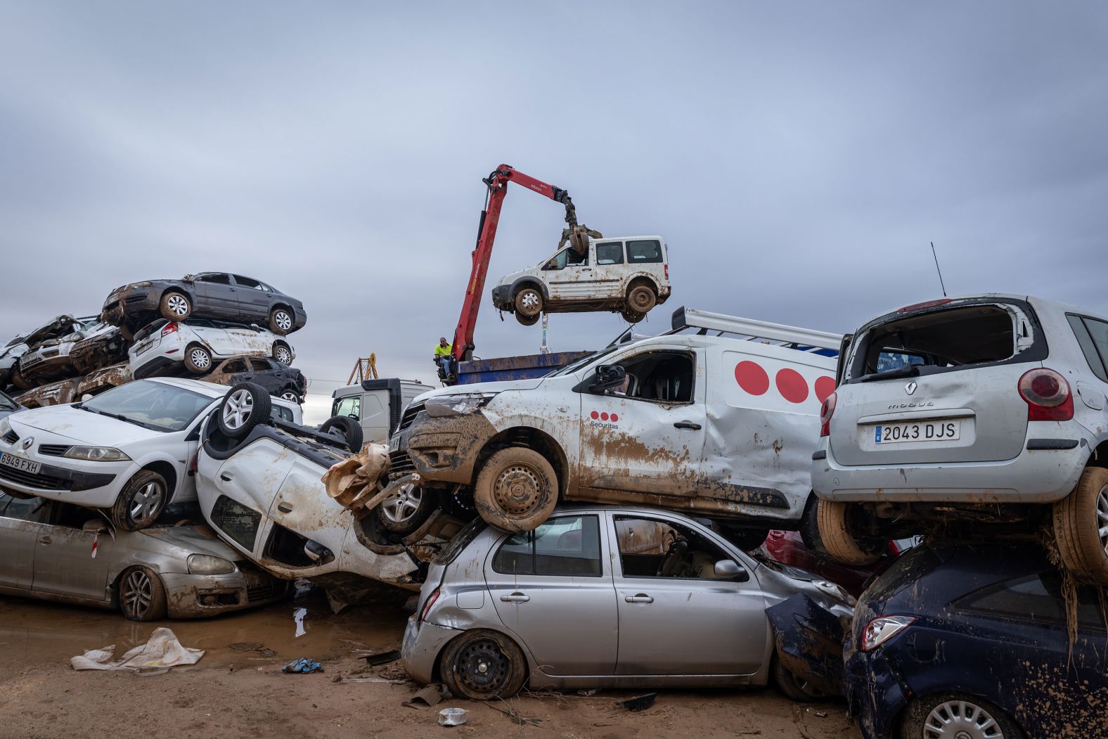 A tow truck collects destroyed cars in Paiporta on Monday.