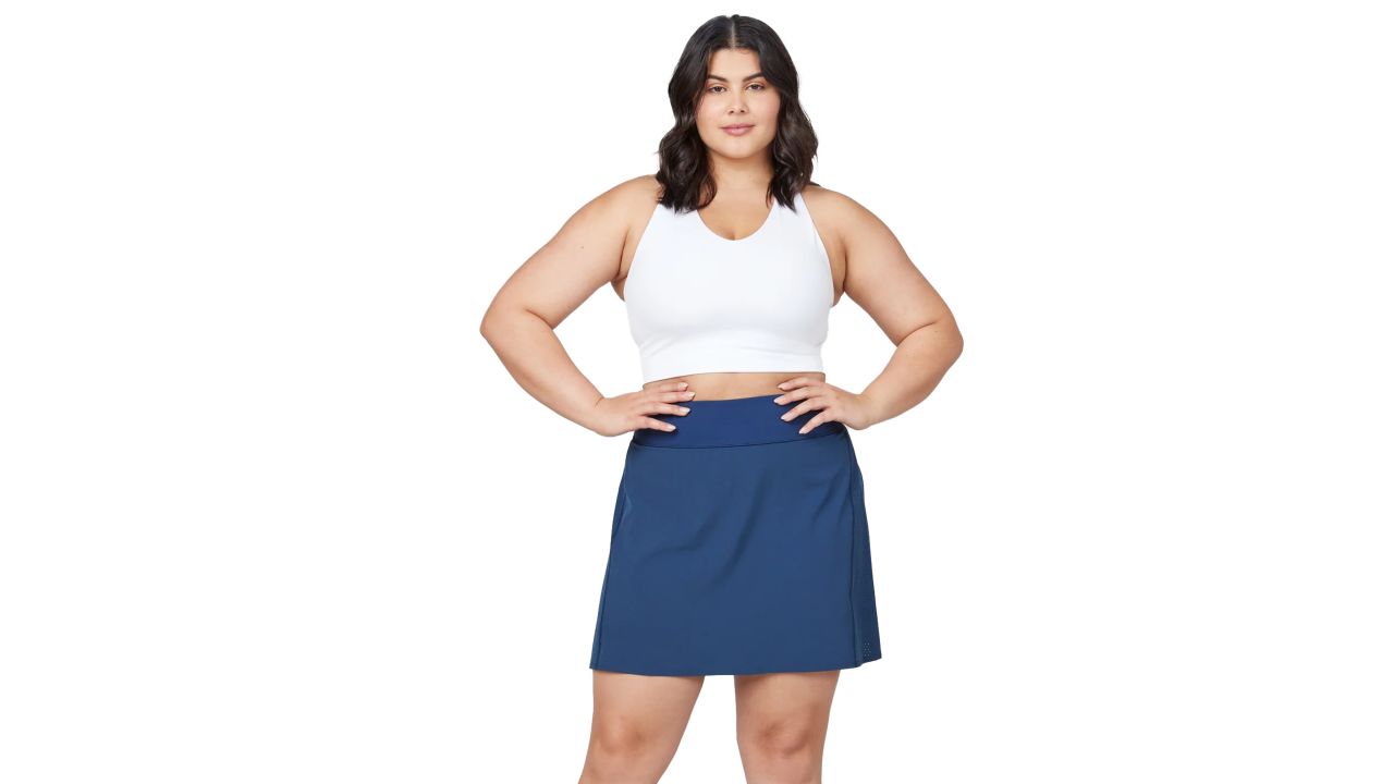 Woman wearing Spanx Get Moving Skort in midnight navy