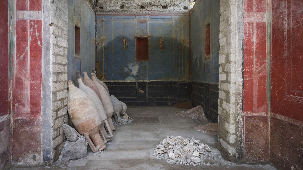 Archaeologists have unearthed an intricately decorated blue room, interpreted as a sacrarium, or a space dedicated to ritual activities and the conversation of sacred objects, during recent evacuations in central Pompeii in Italy.