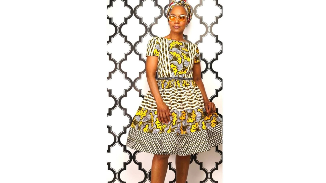 A woman wearing a funky yellow printed dress.