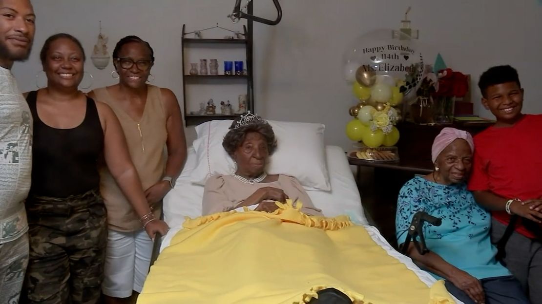 Elizabeth Francis is surrounded by her family members, including her granddaughter, Ethel Harrison (left), and her daughter Dorothy Williams (right), at her 114th birthday party in Houston on July 25, 2023.