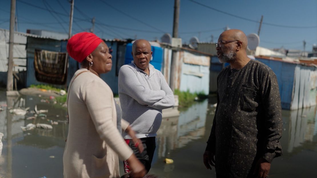 Mpahlwa (right) speaks with residents about the conditions at the Kosovo Informal Settlement in Philippi Township, Western Cape.