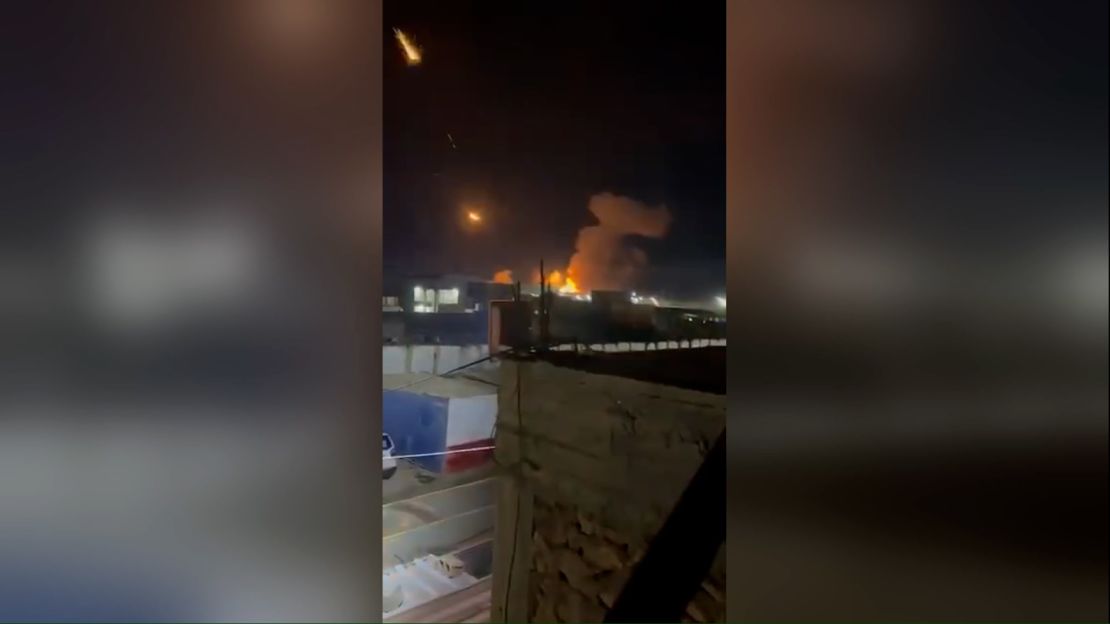 A screengrab from a video, geolocated by CNN to the town of Qaim, Iraq, shows the aftermath of US military strikes in the area, according to the Iraqi Military. An apparent weapons depot was hit, and a number of flares from projectiles were seeing rocketing into the sky.