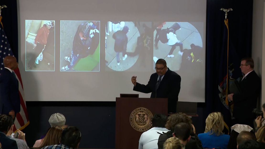 District Attorney Alvin Bragg shows images of three people he said officials are working to identify. The first three people seen from the left have not been identified, he said.