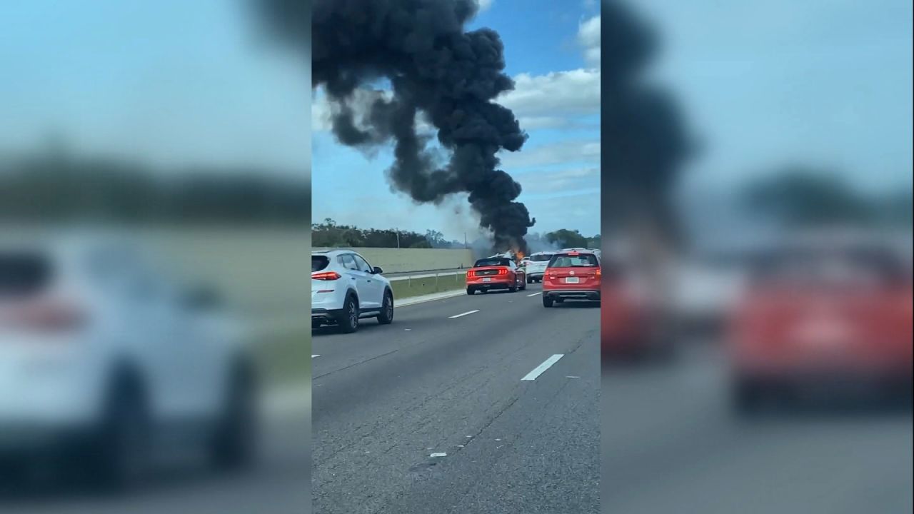 Smoke rises after a private aircraft crashed on the southbound lanes I-75 and collided with a vehicle near the Pine Ridge Road in Naples, Florida, on Friday, February 9, 2024, according to the Florida Highway Patrol.