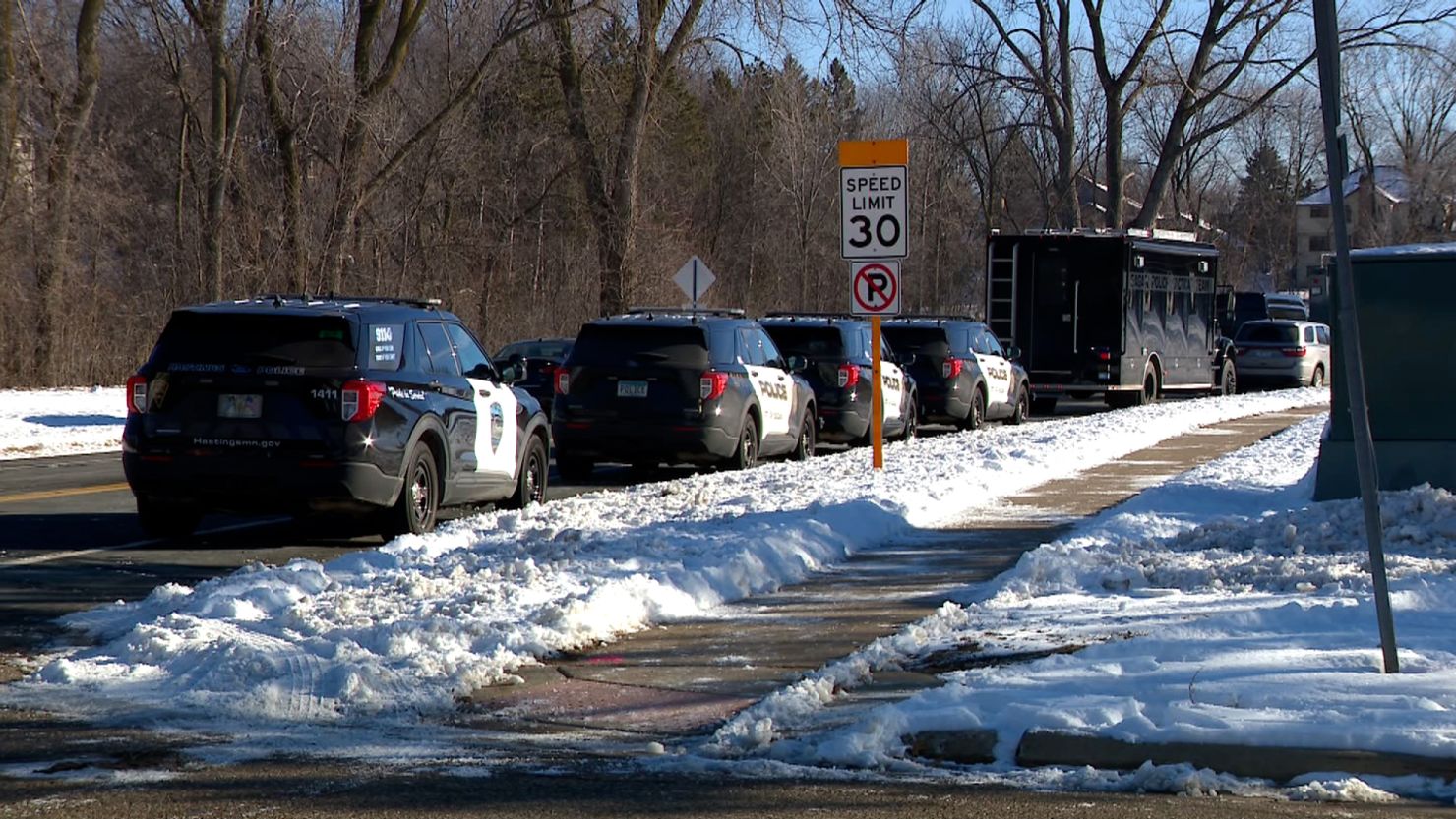 Police vehicles line the scene of a shooting incident on February 18 in Burnsville, Minnesota.