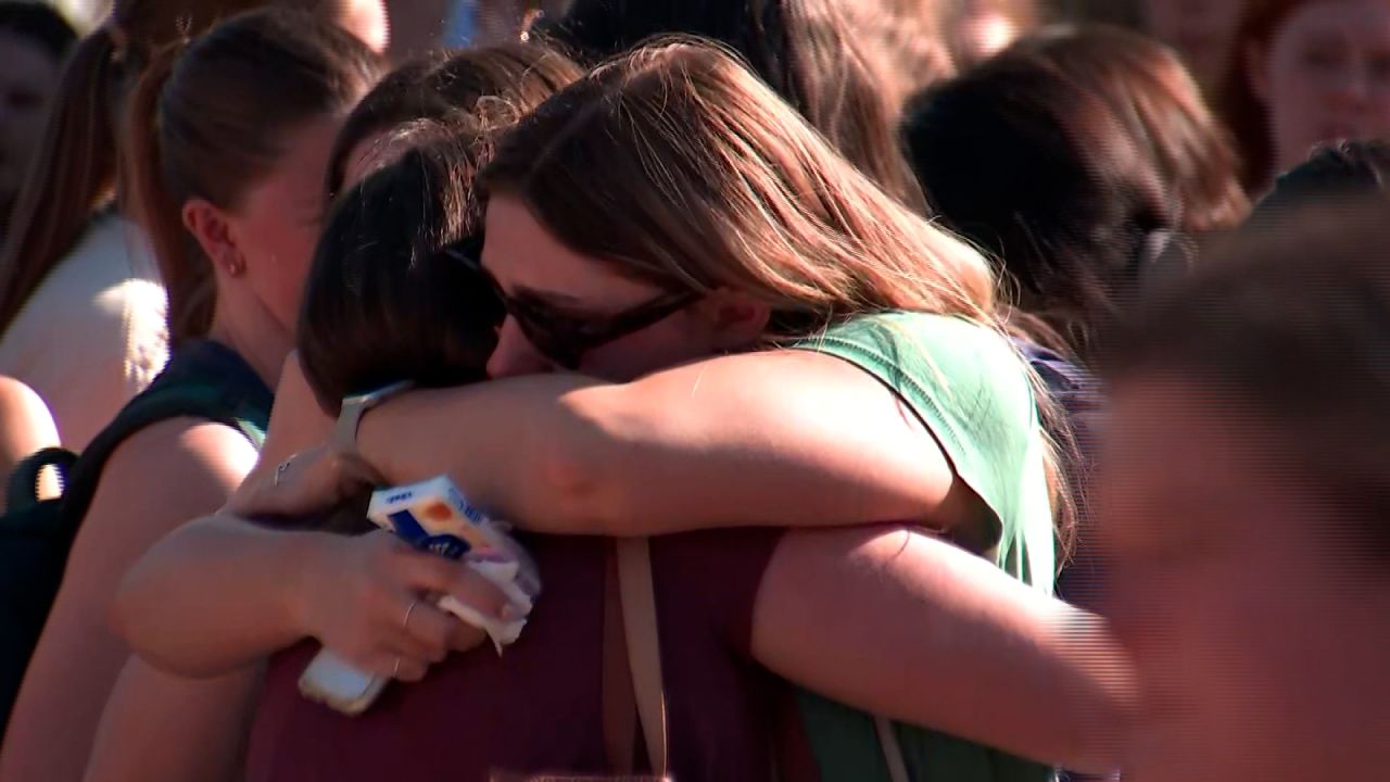 People hug at a vigil for Laken Hope Riley at the University of Georgia in Athens, Georgia, on February 26, 2024.