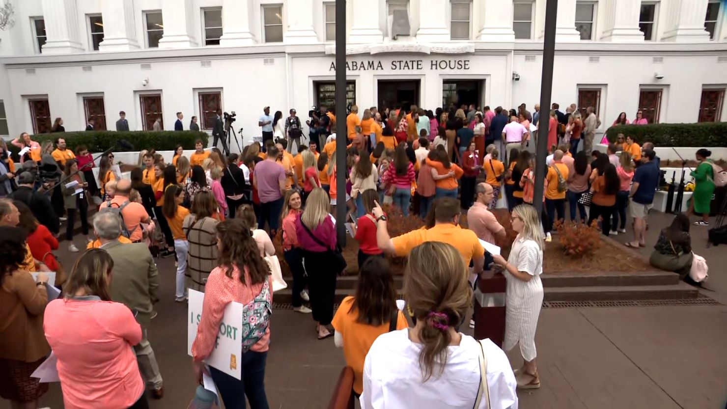 People gather outside the Alabama State House in Montgomery on Wednesday to call for access to IVF treatment.