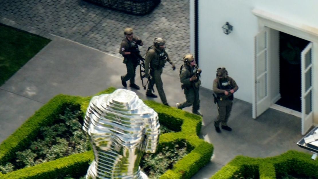Members of law enforcement are seen outside of Sean "Diddy" Combs' home in Los Angeles on March 25, 2024.