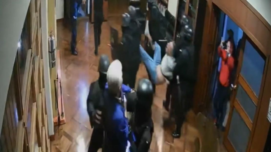 Security camera footage shows Glas being arrested in the Mexican embassy.