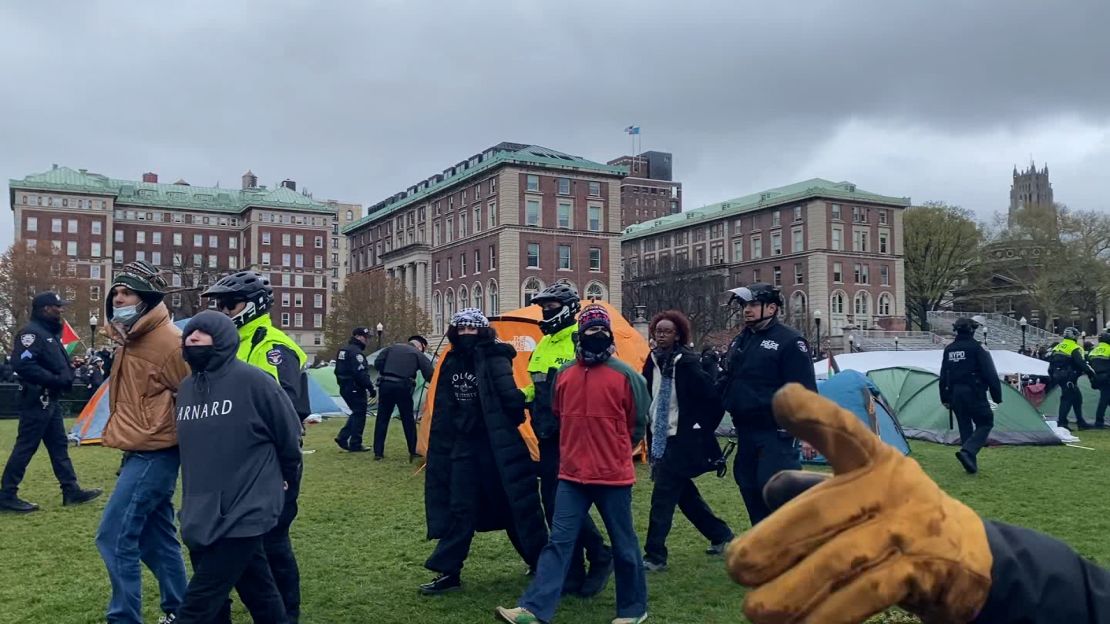 Rep. Ilhan Omar's daughter Isra Hirsi, right, being arrested.