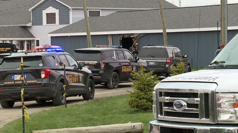 Police respond to the scene after a vehicle drove through a building in Newport, Michigan, on Saturday, April 20.