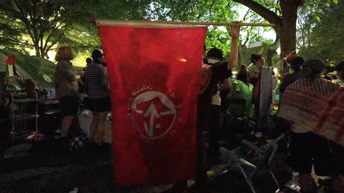 A protester holds a Popular Front for the Liberation of Palestine flag at the University of Pennsylvania on May 1.