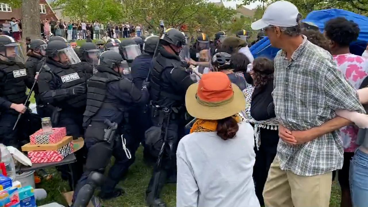 Indiana State Police wearing riot gear attempt to clear out an encampment at Indiana University Bloomington on April 27.