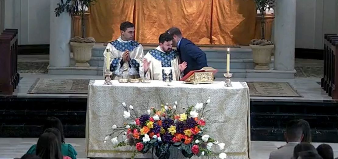 As the incident unfolded, a parishioner approached the altar to whisper in the ear of associate pastor Father Nicholas DuPré.