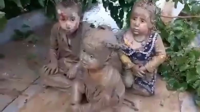 Three children, aged 3, 5 and 6, sit on the roof of a mosque in Baghlan province, after being rescued from flooding and mud torrents that have affected 18 districts across at least three provinces in northern Afghanistan, according to the United Nations’ World Food Programme.