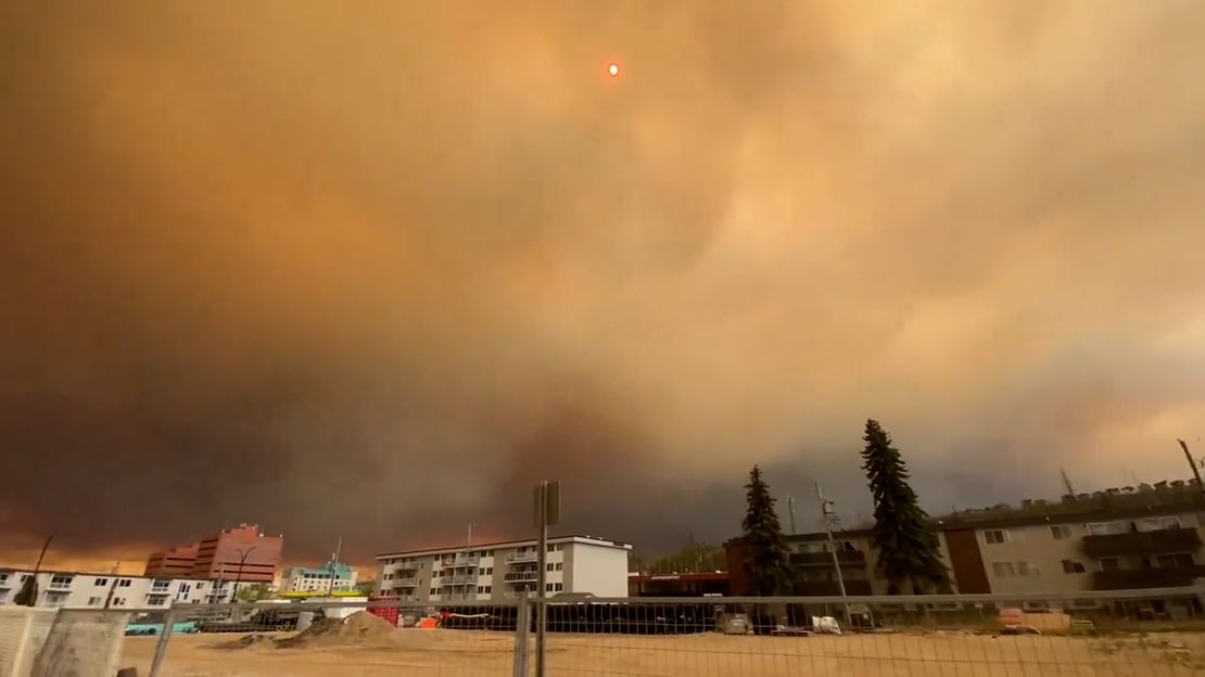 Huge clouds of orange and black smoke fill the sky in downtown Fort McMurray from the wildfires on Tuesday.