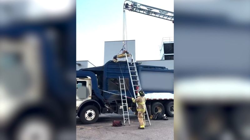 Video shows rescue of man trapped inside garbage truck