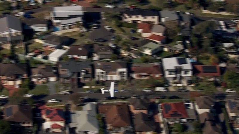 The Cessna plane skimmed across homes and treetops in Sydney's southwest suburb.