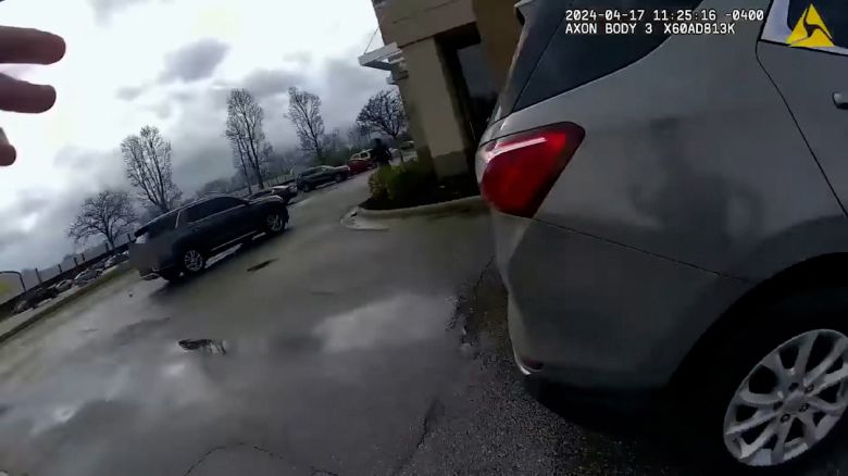 In a screengrab taken from body-worn camera video, a Michigan State Trooper is about to hit a man with his car during a chase. The trooper has been charged with murder. The blurring of the license plate in the video was done by Michigan State Police before its release.